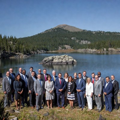 Group of business professionals at mountain lake