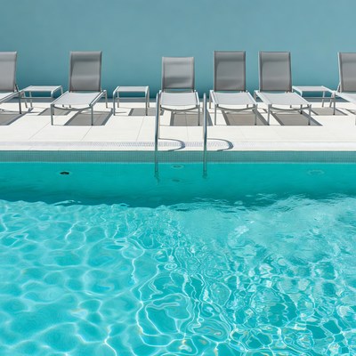 Row of Lounge Chairs by Swimming Pool