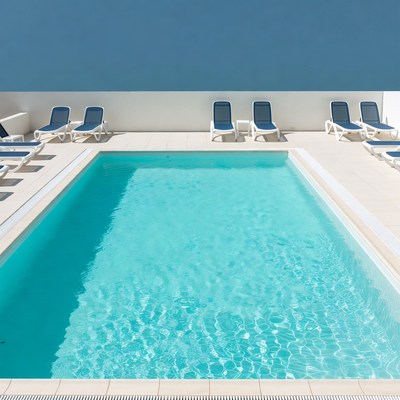 Swimming Pool with Blue Lounge Chairs