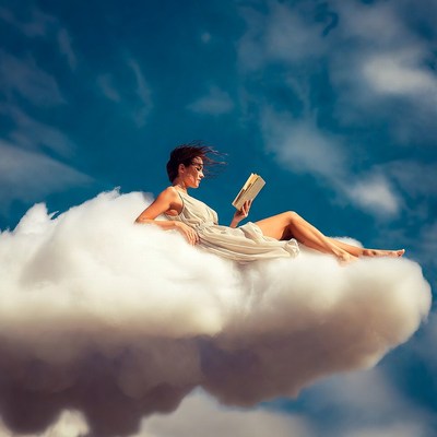 Woman reading book on clouds