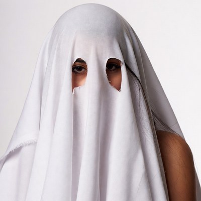 Woman in ghost sheet costume