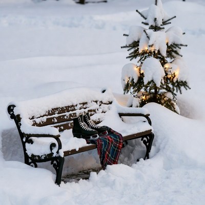 Skates and Plaid Blanket on Snowy Bench