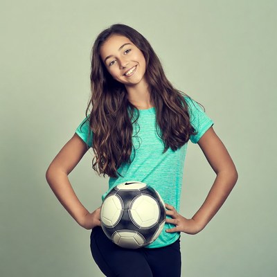 Girl holding soccer ball