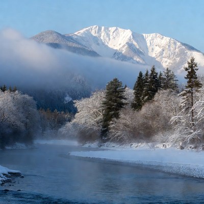 Snowy Mountain River with Foggy Trees
