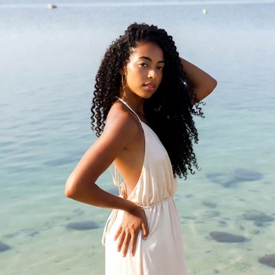 African-American woman in white dress by sea