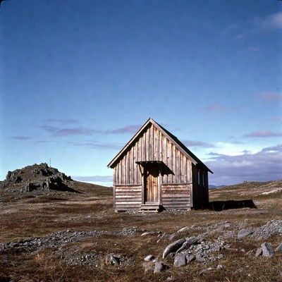 Wooden Cabin on Rocky Tundra