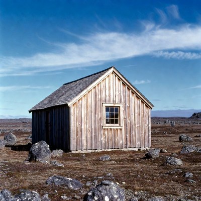 Wooden Cabin in Rocky Tundra
