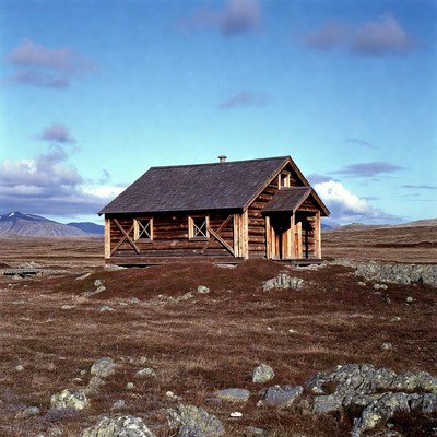 Wooden Cabin in Vast Tundra Landscape