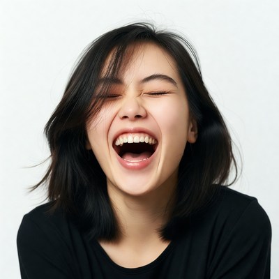 Asian woman laughing with eyes closed