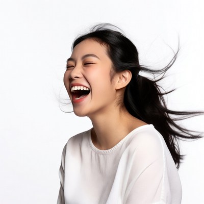 Asian woman laughing with flowing hair