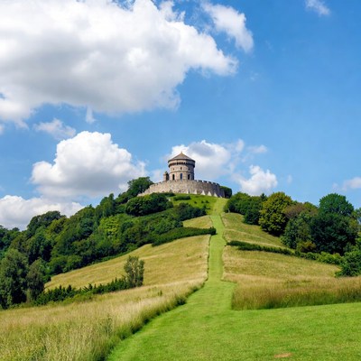 Tower atop green hill path