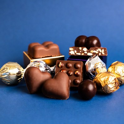 Assortment of chocolates on blue background