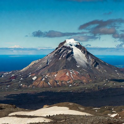 Snow-capped volcano overlooking ocean