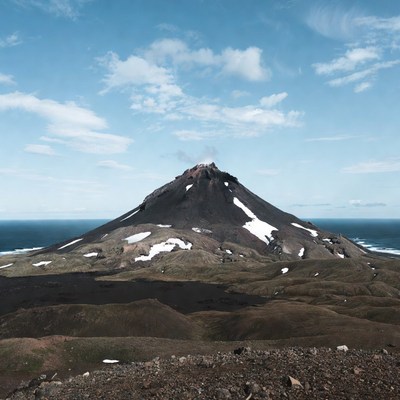 Active volcano erupting by ocean