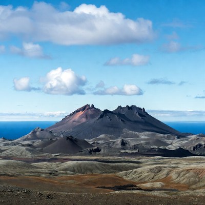 Volcano with ocean and clouds