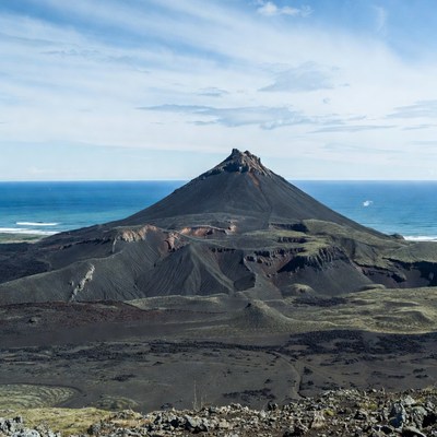Volcanic cone by ocean shore