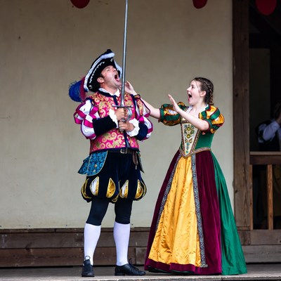 Man and girl in Renaissance costumes acting