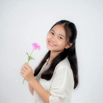 Asian girl holding pink flower