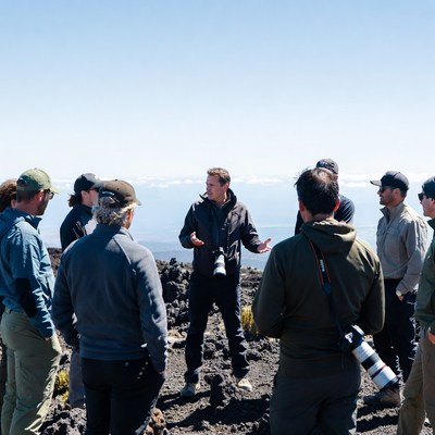 Group of men discussing on volcano