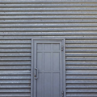 Gray Door on Corrugated Metal Wall