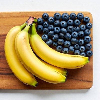 Bananas and Blueberries on Wooden Board