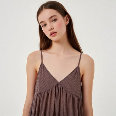 Young woman in dotted spaghetti strap dress