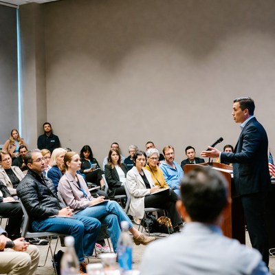 Man speaking at podium to audience