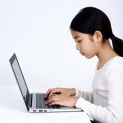 Asian girl typing on laptop