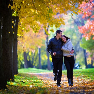 Couple embracing under autumn trees