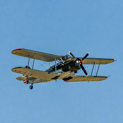 Biplane Flying in Blue Sky