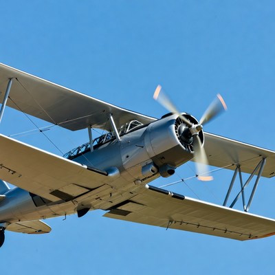 Biplane Flying in Blue Sky