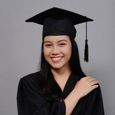 Asian woman in graduation gown