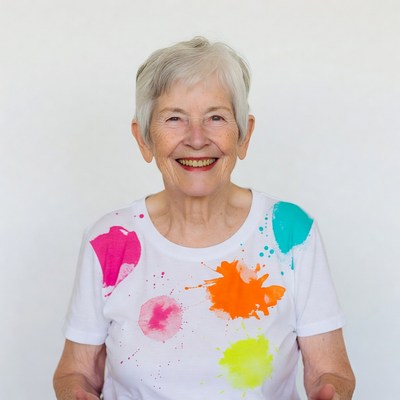 Elderly woman in colorful paint splatter shirt