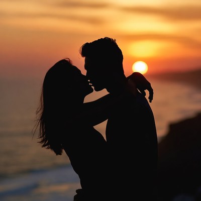 Silhouette couple kissing at sunset