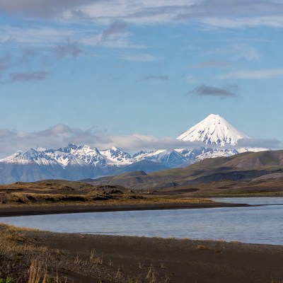Snow-capped volcano over lake