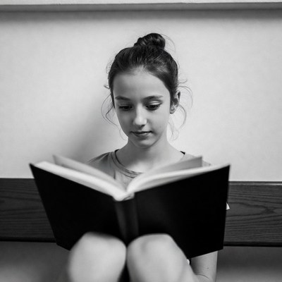 Girl reading book black and white