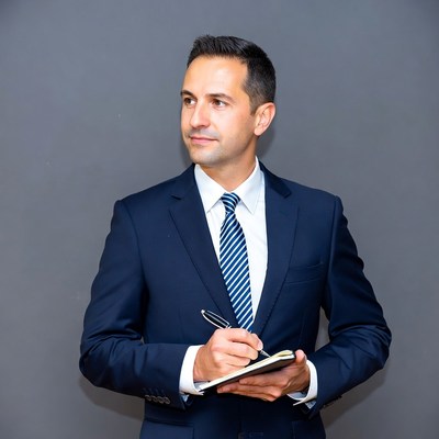 Man writing in notebook in suit