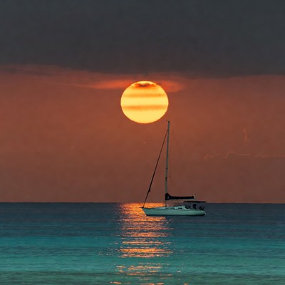Sailboat Silhouetted Against Sunset