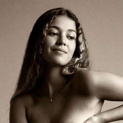 Smiling topless woman with curly hair