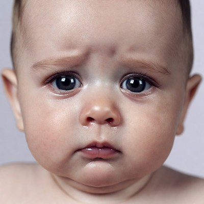 Baby with teary sad eyes