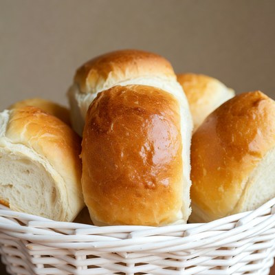 Fresh bread rolls in white basket