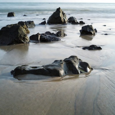 Rocks on beach with ocean waves