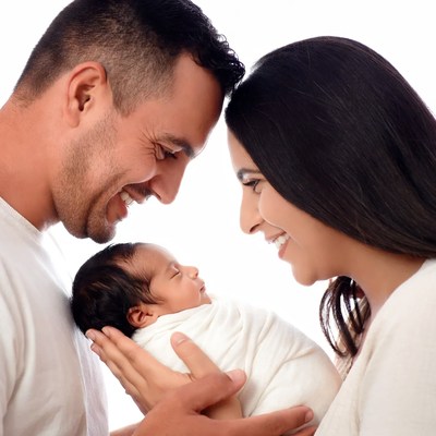 Parents smiling at newborn baby