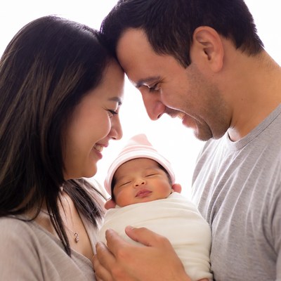 Asian parents holding newborn baby
