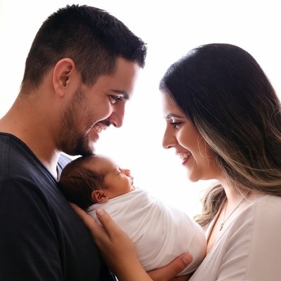 Parents smiling at newborn baby