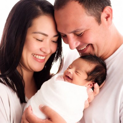 Asian family holding newborn baby