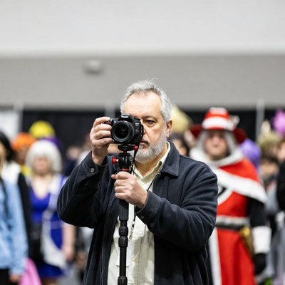 Man photographing cosplayers at convention