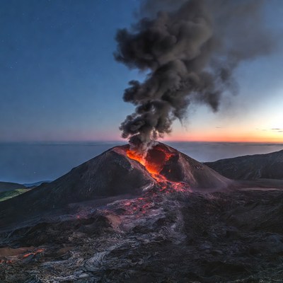 Volcano erupting at twilight