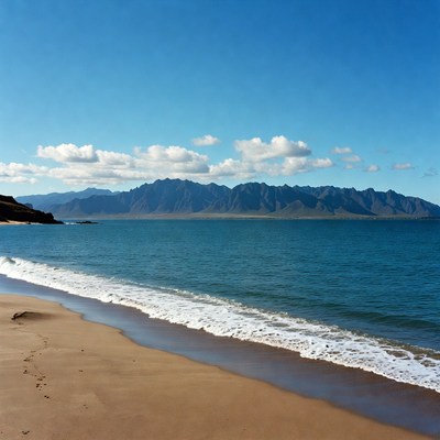 Sandy Beach with Distant Mountains