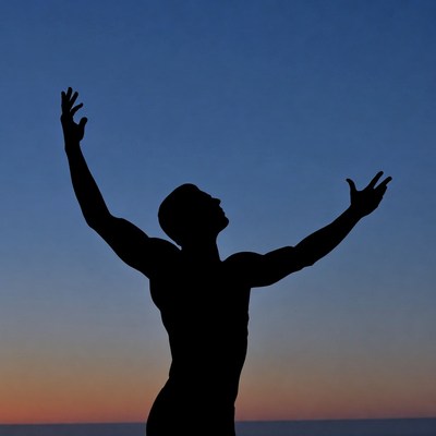 Man raising arms silhouette sunset